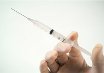 hand holding a syringe